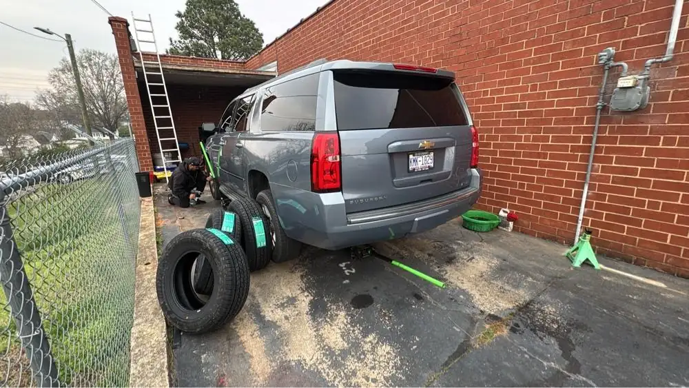 Tire swap on a Chevy Suburban beside the shop